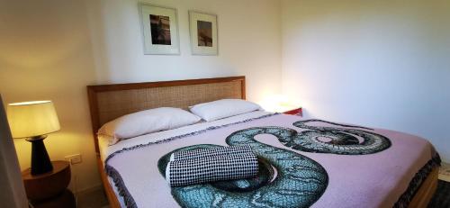 a bed with a snake on top of it at Casa Remy - Walk to the Beach and stay in a private compound! Pool, Kitchen, AC, Wi-Fi in Mal País