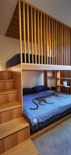 a bedroom with a bunk bed with a staircase at Casa Remy - Walk to the Beach and stay in a private compound! Pool, Kitchen, AC, Wi-Fi in Mal País