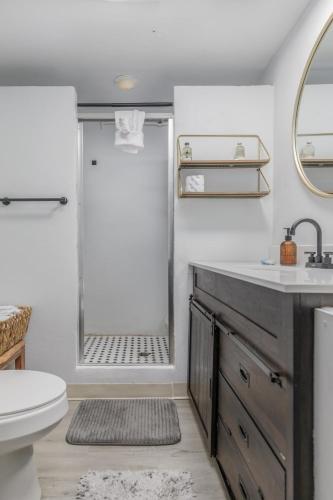 a bathroom with a shower and a sink and a toilet at Bear Suite - King Bed Cabin Apartment in Gatlinburg