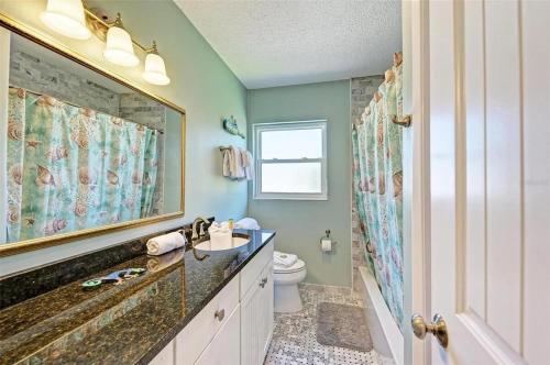 a bathroom with a sink and a toilet at Anna Maria Island Beach Front Condo - 50 steps to Beach in Holmes Beach
