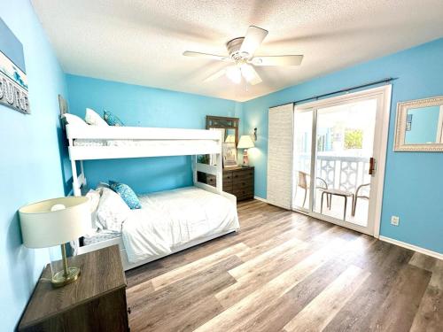 a bedroom with a bed and a ceiling fan at Anna Maria Island Beach Front Condo - 50 steps to Beach in Holmes Beach