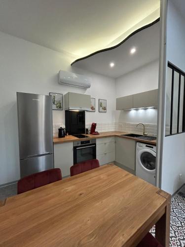 Il dispose d'une cuisine avec une table en bois et une cuisinière. dans l'établissement Appartement Menton, à Menton