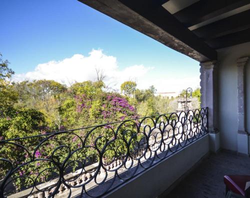 a balcony with a view of trees and flowers at Hotel Boutique Casa del Jardín Aguascalientes in Aguascalientes