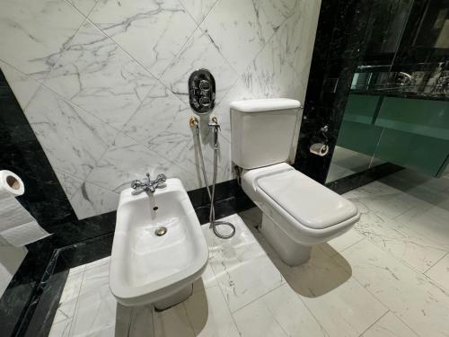 a bathroom with a white toilet and a bidet at The Bishop in London