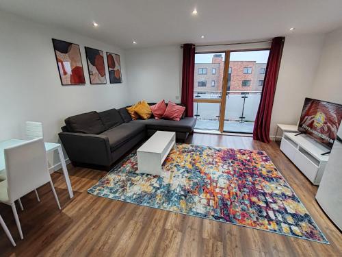 a living room with a couch and a rug at London Apartment with Wembley view in London
