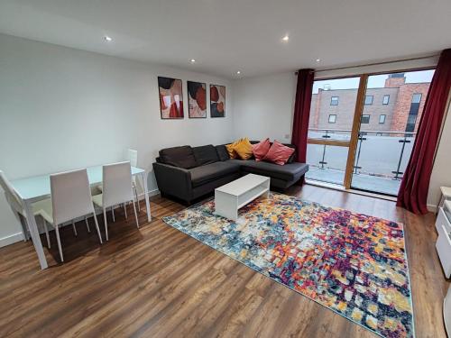 a living room with a couch and a table at London Apartment with Wembley view in London