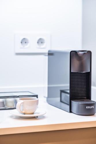 a coffee maker and a cup on a counter at Machim D Arfet House by Homie in Machico