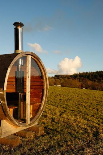 a wooden barrel with a light in a field at Tranquil Tigín - your Little Holiday in Wicklow in Wicklow