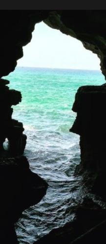 a view of the ocean from inside a cave at Appartement de vacances neuf: piscines et plage in Tangier