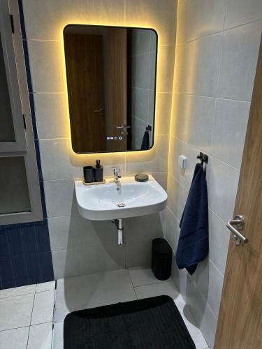 a bathroom with a sink and a mirror at Luxury apartment with 3 pools in Cabo Negro