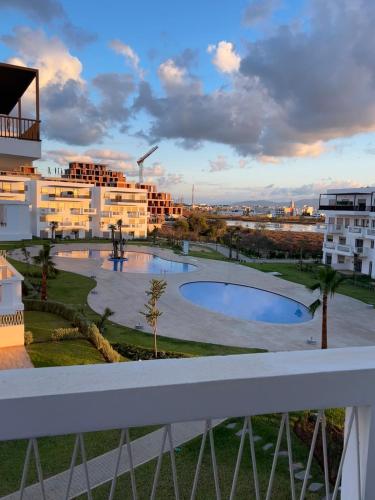 a view from the balcony of a building with a pool at Luxury apartment with 3 pools in Cabo Negro