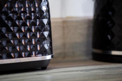 a close up of the heel of a black shoe at Bradford Luxury Central Apartment in Bradford