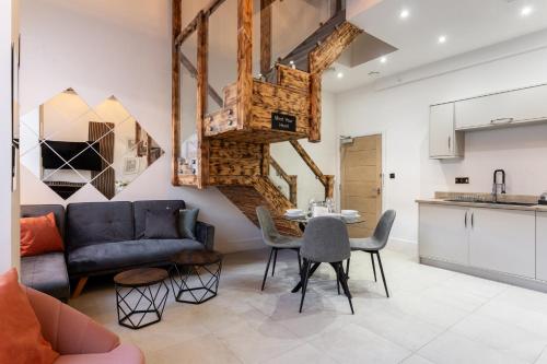 a living room with a couch and a table at Bradford Luxury Central Apartment in Bradford