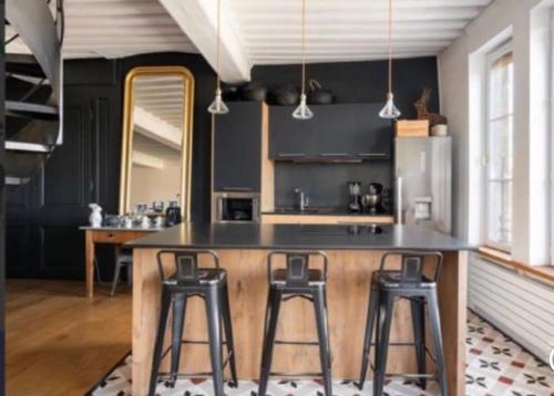 une cuisine avec un grand comptoir et des tabourets de bar dans l'établissement Le Prestige Vieux Lyon, Duplex Vue sur la Saône, à Lyon