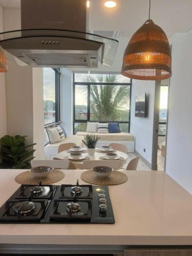 a kitchen with a stove and a living room at Almare Apartamentos nuevos in Gustavo Rojas Pinilla International