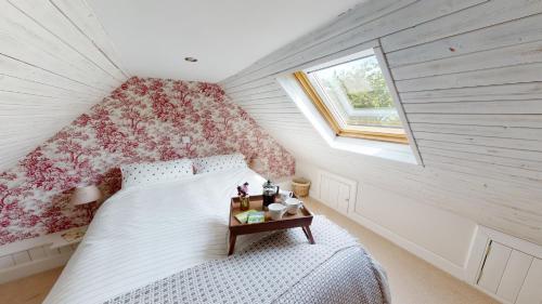 a small bedroom with a bed and a window at Mrs Moll's Cottage in Earlston
