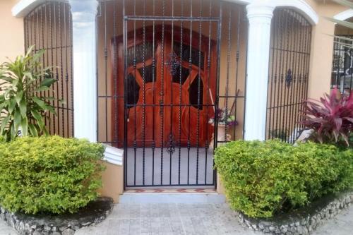 a gate in the front of a house at Elegant Villa in Nagua with Private Pool and Jacuzzi in Nagua