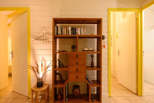 a room with a book shelf in a room at Chez Marie & Philippe Ti'Kaz Vanille in Cadet
