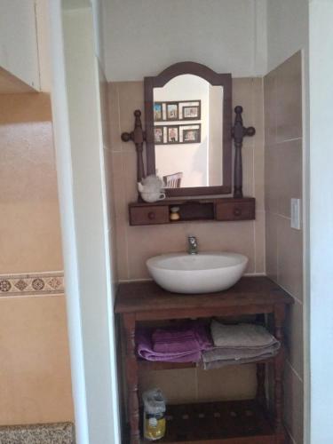 a bathroom with a sink and a mirror at vistas del valle in Villa Carlos Paz