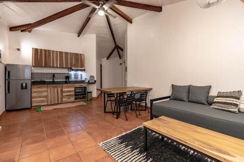 a living room with a couch and a table at SoulShine in Playa Avellana