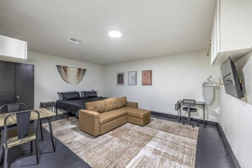 a living room with a couch and a bed at Elegant Private Studio Sleeps 4! 10Min to Strip! in Las Vegas