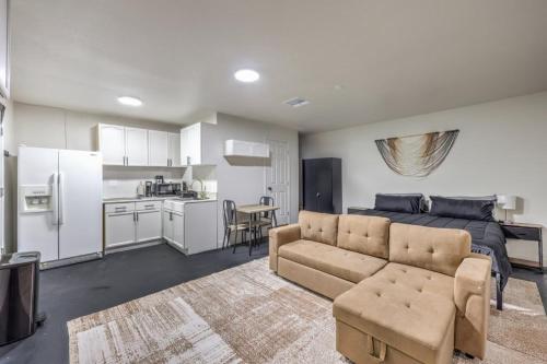 a living room with a couch and a kitchen at Elegant Private Studio Sleeps 4! 10Min to Strip! in Las Vegas