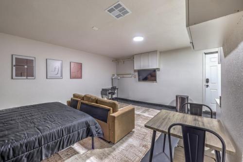 a bedroom with a bed and a couch and a table at Elegant Private Studio Sleeps 4! 10Min to Strip! in Las Vegas