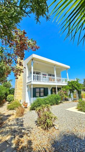a large house with a balcony on top of it at Villa Mira - 3BR Villa with Panaromic Sea View in Datca