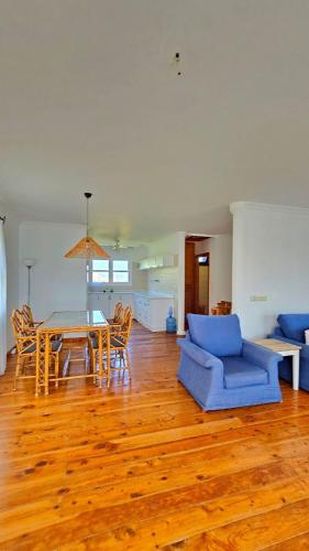 a living room with a table and a blue couch at Villa Mira - 3BR Villa with Panaromic Sea View in Datca