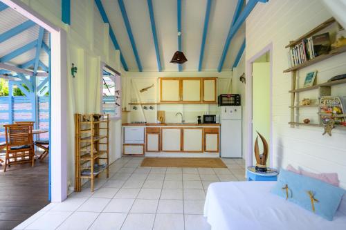 a room with a kitchen with a bed and a table at Chez Marie & Philippe Ti'Kaz Cannelle in Cadet