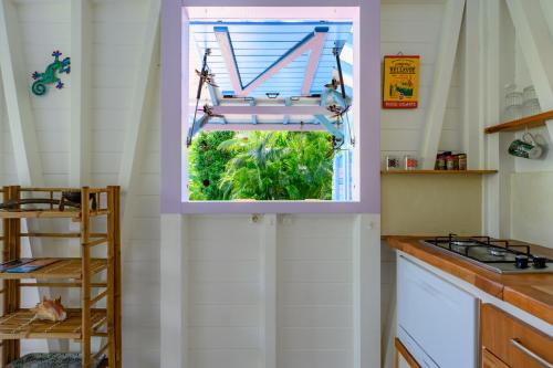 a kitchen with a window and a sink at Chez Marie & Philippe Ti'Kaz Cannelle in Cadet