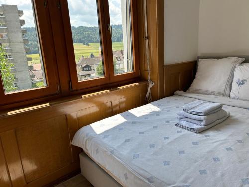 a bedroom with a bed with two towels on it at Studio in Tramelan