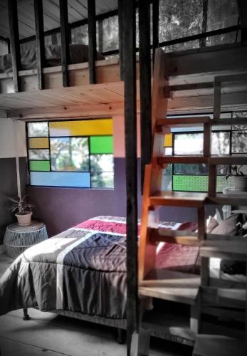 a bedroom with a bed and stained glass windows at Art & Coffee in Santa Cruz La Laguna
