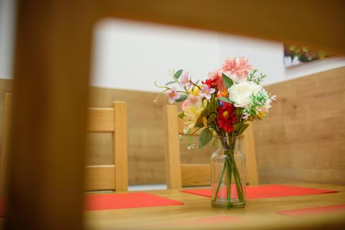 a vase of flowers sitting on a table at Apartmány Volavka 2 in Planá nad Lužnicí
