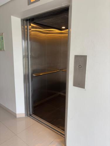 a glass door to a shower in a building at Roxroy on Fifth SMDC Cheer Residences in Marilao