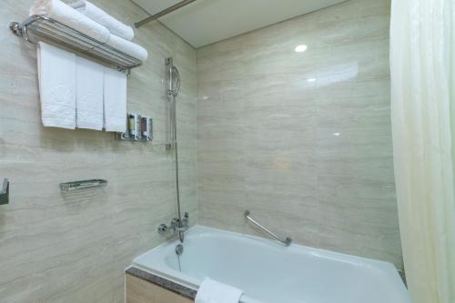 a bathroom with a bath tub and a sink at Stanford Hotel Seoul in Seoul