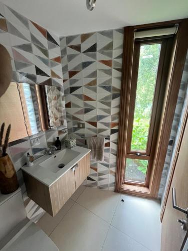 a bathroom with a sink and a large window at La Casa Del Lago in Puerto Octay