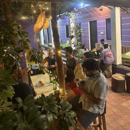 a group of people sitting around a table in a room at Tamasha Goa Vagator in Vagator