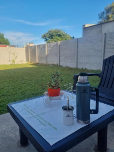 a picnic table with a thermos and a plant on it at Tu descanso en Coronel Suarez in Coronel Suárez