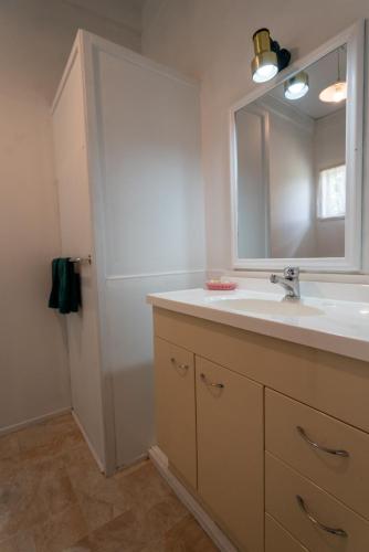 a bathroom with a sink and a mirror at Casa Mexicana in Paeroa