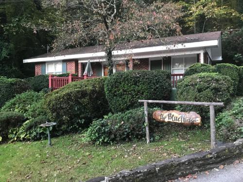 a house with a sign in front of it at Mountain Aire Cottages, Inn, & Glamping in Clayton