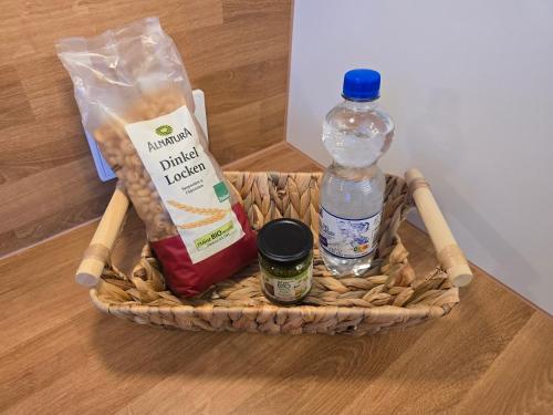 a basket with a bottle of water and other groceries at Sonnenhang im Boho-Stil mit Balkon, 500m zum See, 2 Schlafzimmer in Möhnesee