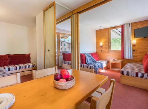 Cette chambre comprend une table avec un bol de fruits. dans l'établissement Les Terrasses Blanches - Appartement Belle Plagne - 4 personnes - Exposition plein Sud - Sur pistes, à La Plagne Tarentaise