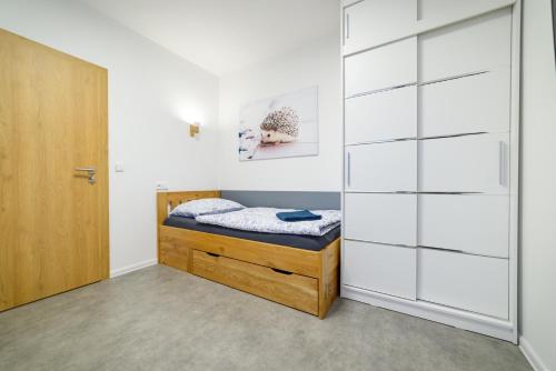 a bedroom with a bed and a closet at Apartmány Volavka 1 in Planá nad Lužnicí