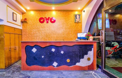an office with a desk with an oo sign on a wall at Hotel O Embassy in Bodh Gaya