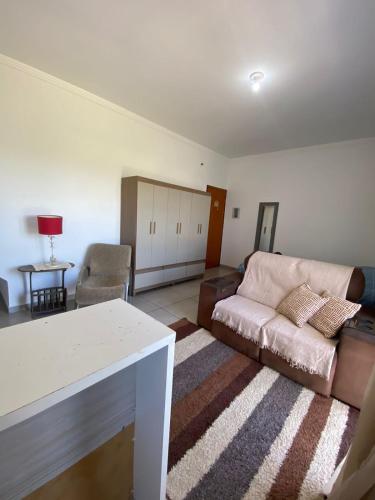 a living room with a couch and a table at Lofts Rocha Setville in São José dos Campos