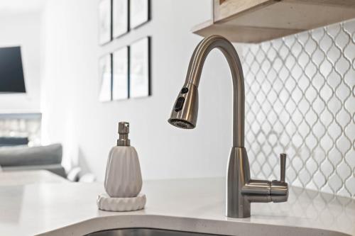 a kitchen sink with a soap dispenser next to it at B233 Mountain View 2BD 2BT AC BonFire BBQ Townhome Close to Banff in Canmore