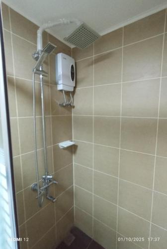 a shower with a shower head in a bathroom at 2 Bedroom Condo Unit Cebu Spacious and Convenient in Cebu City