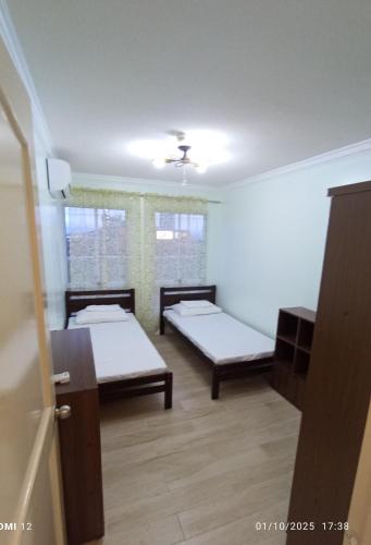 a room with two beds and a window at 2 Bedroom Condo Unit Cebu Spacious and Convenient in Cebu City