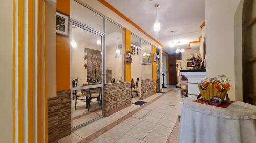a hallway with a table and a dining room at Hostal Montañes in La Paz